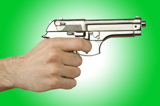 Пістолет в руці проти градієнта
 - Фото, зображення