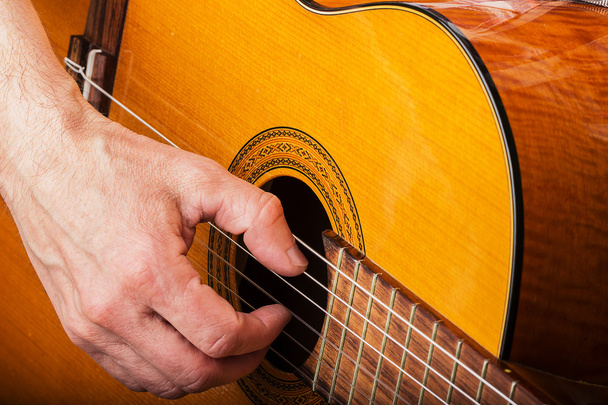 Male hands playing on classical guitar - 写真・画像