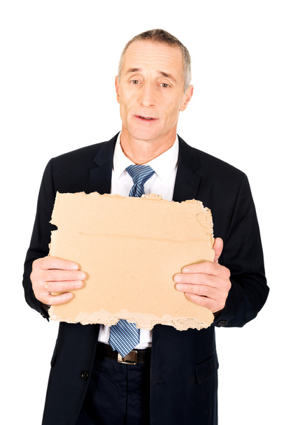 Businessman holding a piece of cardboard - Fotoğraf, Görsel