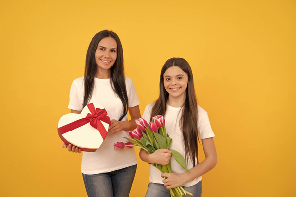 march 8. happy mother and daughter with tulip flowers and present box. - Photo, Image