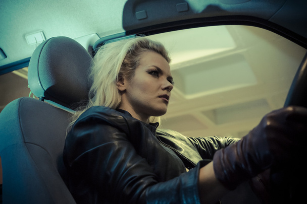 Blonde in car driving at night - 写真・画像