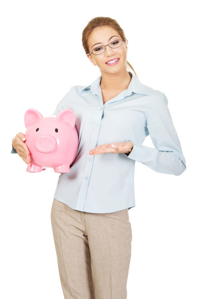 Woman holding piggy bank. - Фото, изображение