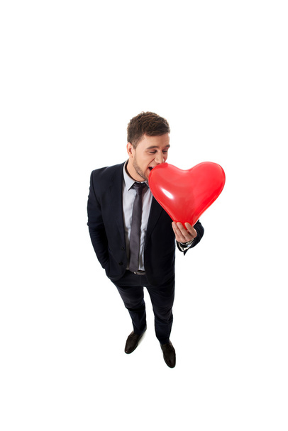 Businessman with heart shaped balloon. - Zdjęcie, obraz