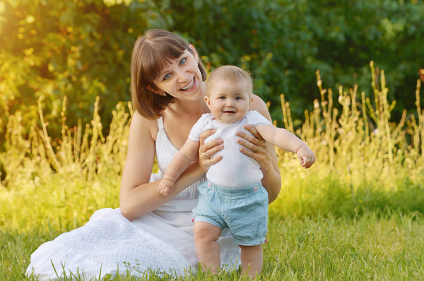 mother with baby on green grass - Photo, Image