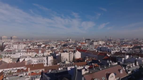 Aerial view of buildings in residential urban neighborhood. Forwards fly above roofs in metropolis on sunny autumn day. Vienna, Austria. - Footage, Video