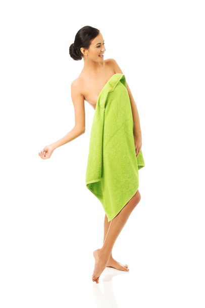 Woman standing wrapped in towel - Photo, Image