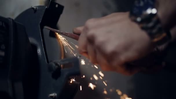 Feche as mãos de um machado afiador em um moedor elétrico belas faíscas
 - Filmagem, Vídeo