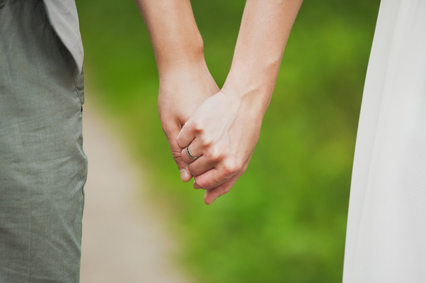 man and woman holding hands. young couple in love standing toget - Photo, Image