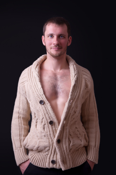 Portrait of a beautiful young man in sweater - Fotó, kép