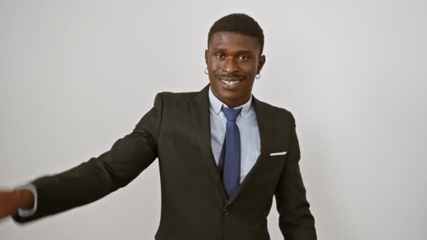 Smiling african american man in business suit showing number one sign, confidently pointing upwards. isolated on a white background, his positive expression radiates happiness. - Footage, Video