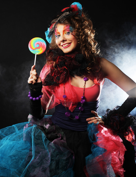 Girl with with creative make-up holds lollipop. - Valokuva, kuva