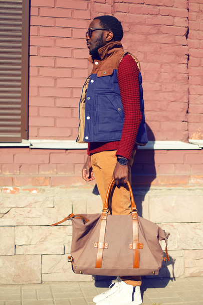 Street fashion concept - handsome stylish african man with bag i - Fotoğraf, Görsel