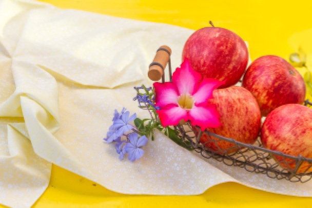 fresh red apples with flowers on natural background - Fotó, kép