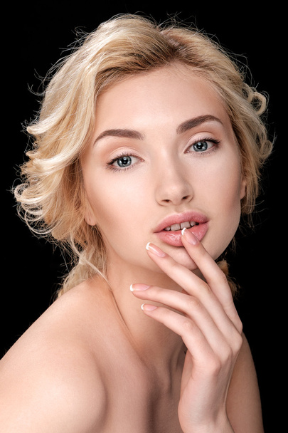 Beautiful blonde woman with clean skin. Finger touches lips. - Photo, image
