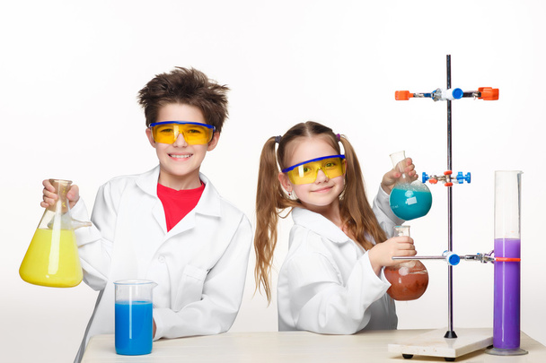 Two cute children at chemistry lesson making experiments - 写真・画像