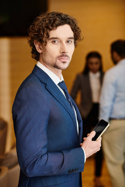 Businessman in sleek attire using smartphone. - Photo, Image