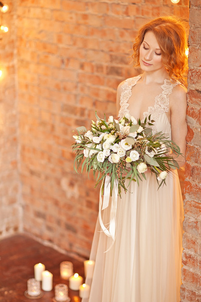 Tender beauty portrait of bride with flowers bouquet - Fotó, kép