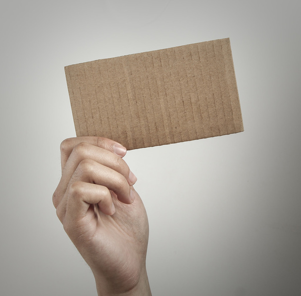 Holding blank brown card - Фото, изображение