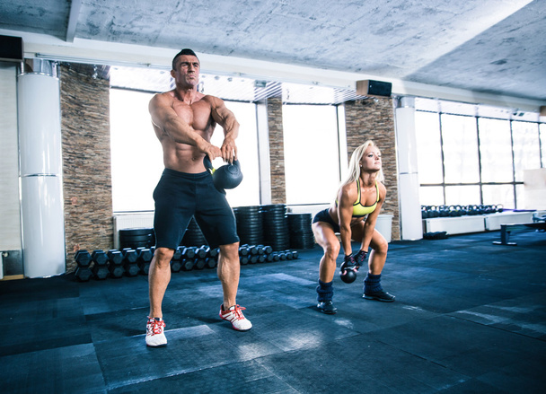 Group of a man and woman workout with kettle ball - Foto, afbeelding