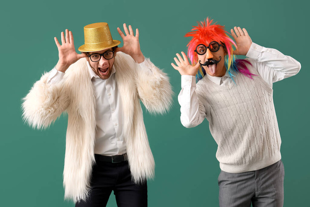 Business men in funny disguise grimacing on green background. April Fools' Day celebration - Photo, Image