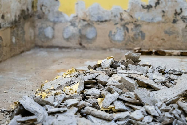 A room under renovation with debris of broken walls and plaster on the floor - Photo, Image