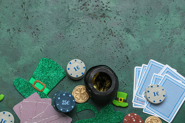 Poker chips with cards and decorations for St. Patrick's Day celebration on green grunge background - Photo, Image