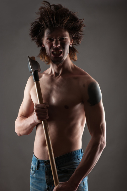 Aggressive dirty man with an ax in hands - Photo, Image