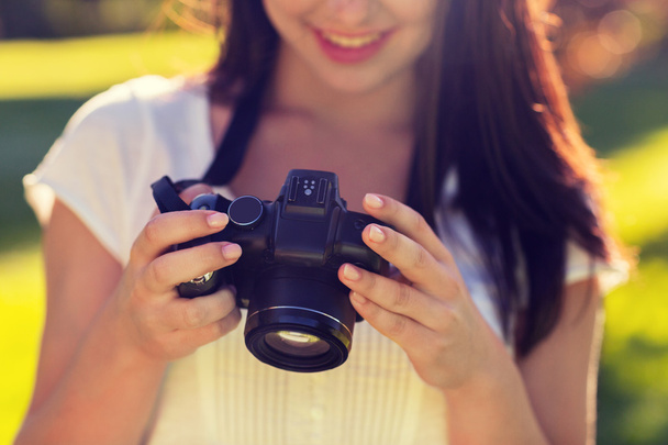 close up of young girl with photo camera outdoors - Foto, Imagem