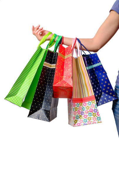 Ženská ruka drží vícebarevná nákupní tašky - Fotografie, Obrázek