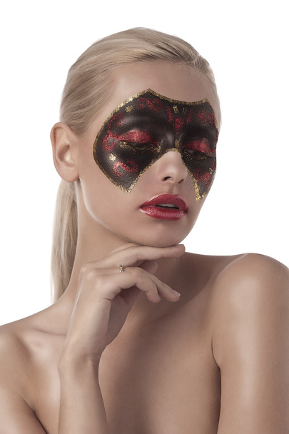 Young blonde with painted carnival mask on face - 写真・画像