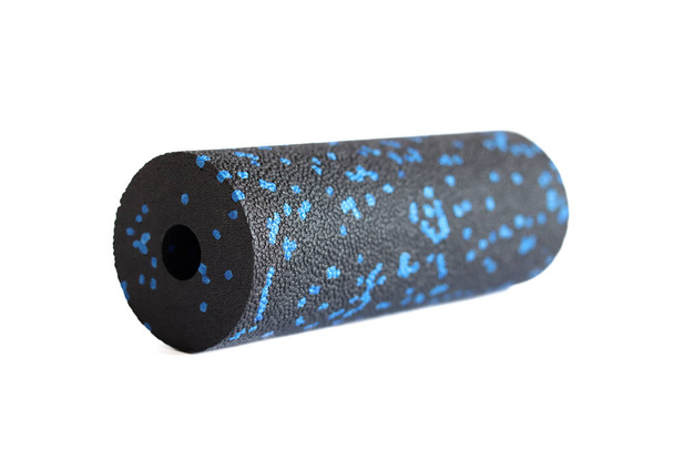 A black blue massage foam roller isolated on a white background. Close-up. Foam rolling is a self myofascial release technique. Concept of fitness equipment. - Photo, Image