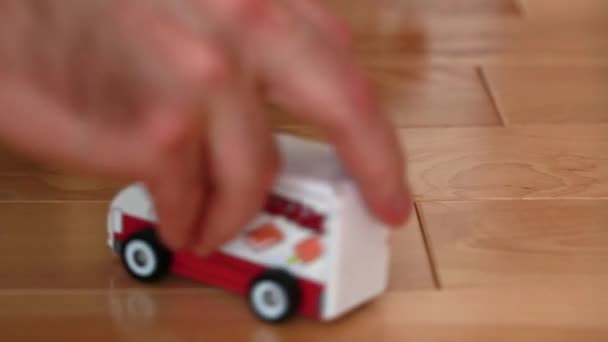 A father plays toy cars - Filmati, video