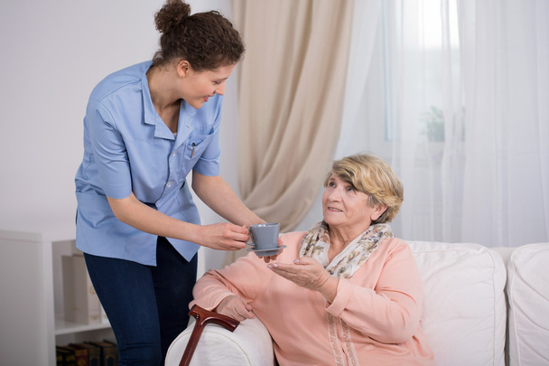 Caregiver caring about elder lady - 写真・画像
