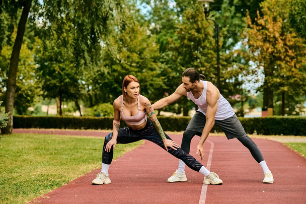 A woman in sportswear being guided by a personal trainer, exuding determination and motivation. - Photo, Image