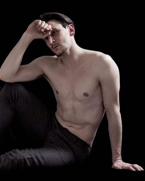 Bare-chested man portrait sitting and thinking - Фото, зображення