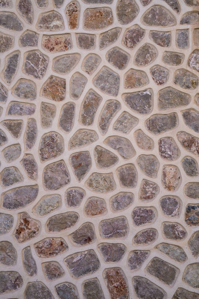 Fotografía plana de una pared de piedra de colores. Textura de fondo piedra - Foto, imagen