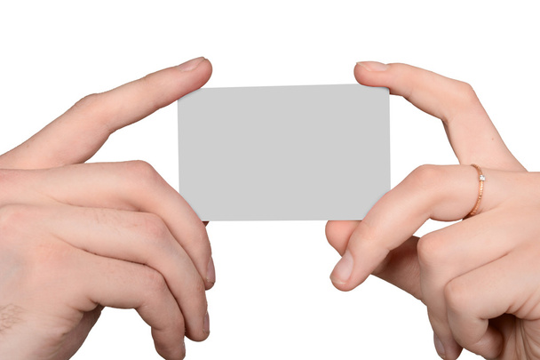 Mano masculina y femenina sosteniendo una tarjeta en blanco
 - Foto, imagen