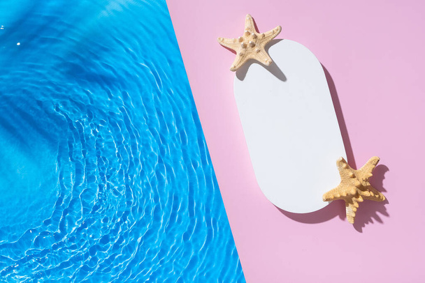 Hot summer scene mock up podium or pedestal on pink background flat lay with blue water waves. - Photo, Image