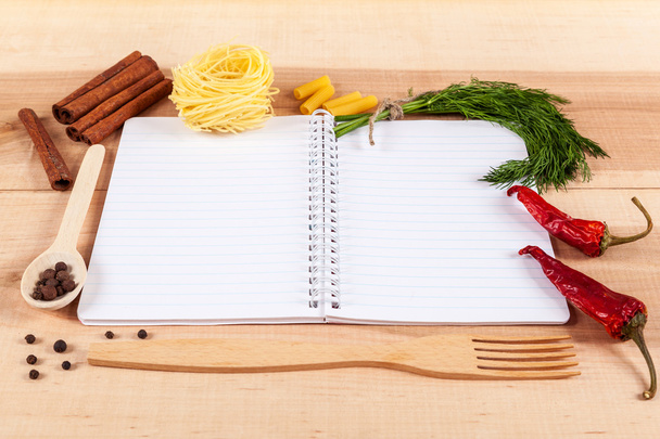 Baking ingredients for cooking and notebook for recipes. - 写真・画像