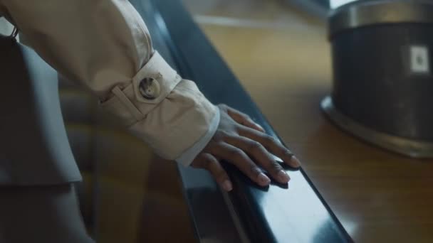 Повернення крупним планом руки невпізнаваного пасажира, який тримається за підозрюваного в безпеці під час висхідного ескалатора на станції метро - Кадри, відео