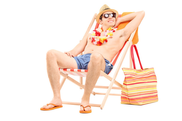 Shirtless man sitting in a sun lounger - Фото, зображення