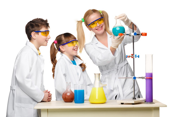 Teens and teacher of chemistry at  lesson making experiments - Photo, Image