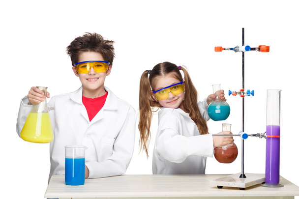 Two cute children at chemistry lesson making experiments - Foto, Bild