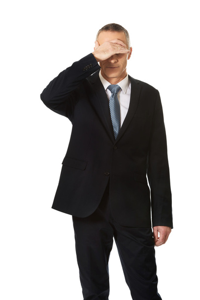 Stressed businessman covering his face - Foto, afbeelding