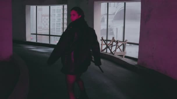 Street fashion. A young girl walks through the city at night. - Footage, Video