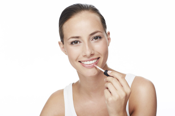 Woman applying lip gloss - Photo, image