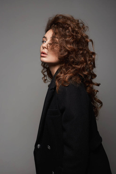 Fashion portrait of Winter style Beautiful curly young woman. sensual girl with make-up and curls Hair - Photo, Image