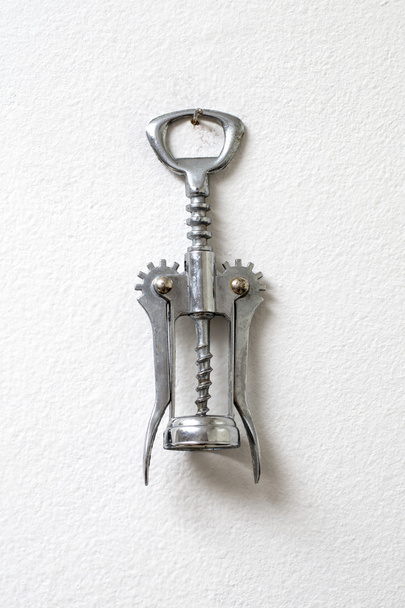 corkscrew hanging against white wall - 写真・画像