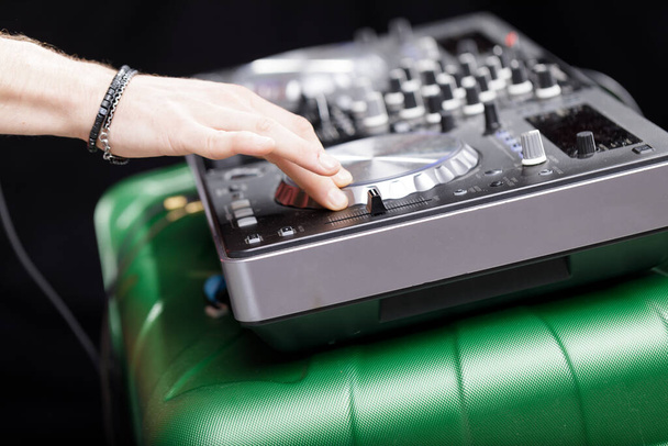 Ρυθμίσεις μίξερ ρυθμίζονται από έναν DJ, προβάλλοντας τα παρασκήνια της δημιουργίας μουσικής - Φωτογραφία, εικόνα