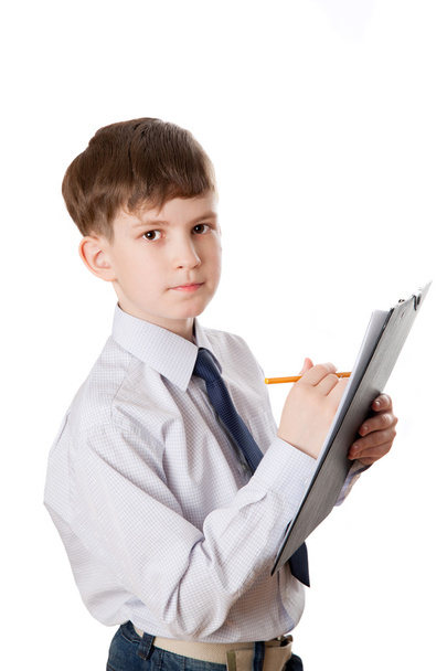 Serious boy with clipboard - Фото, изображение